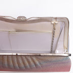 Close-up of fold-away chain hinge inside silver-tone metal frame, white silk lining