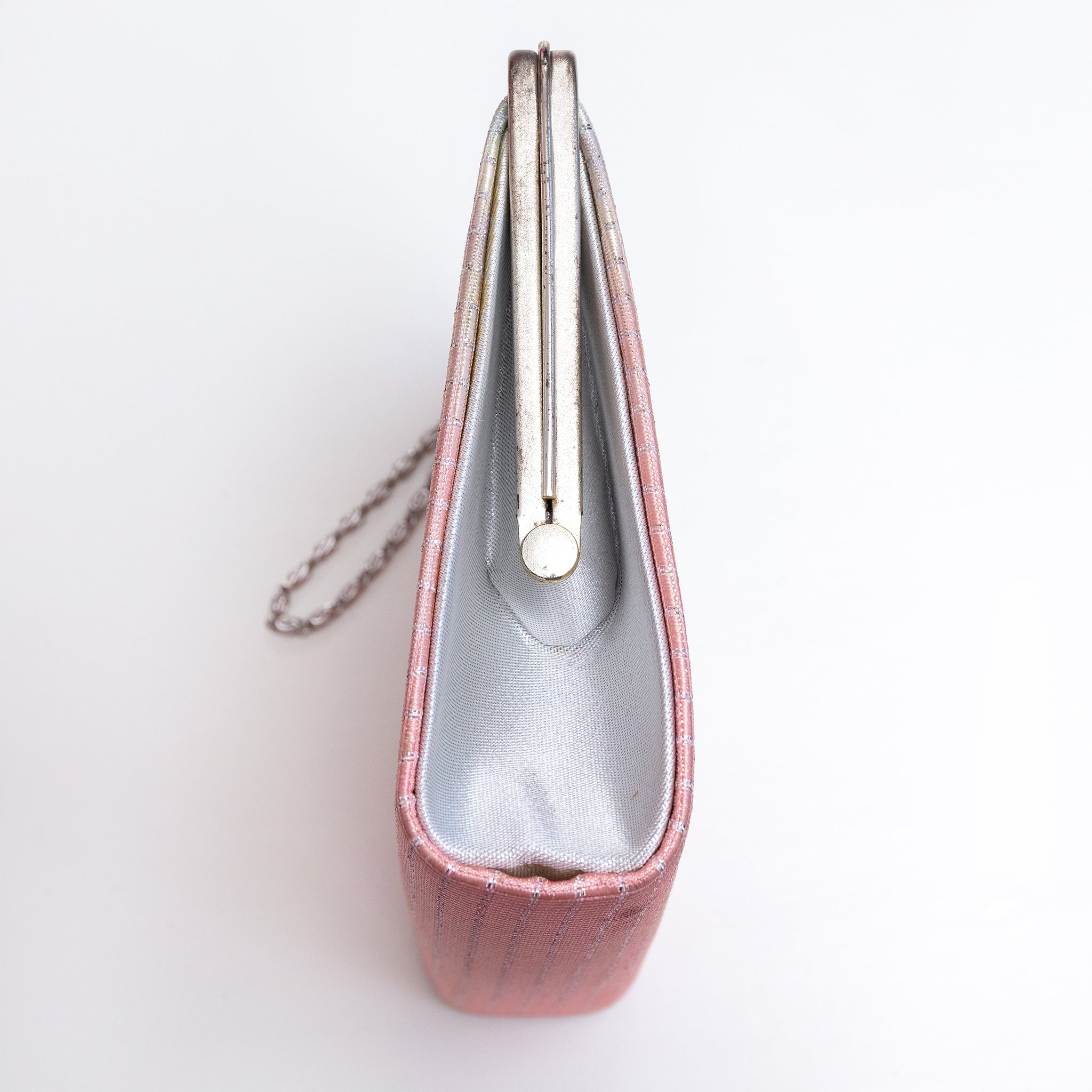 Side view of vintage Japanese clutch bag with plain silver metallic silk side panel