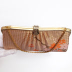 A vintage clutch purse with a gold-tone metal frame, pleated gold and orange silk checked pattern with crane and blossom. Fancy gold clasp and gold chain strap.