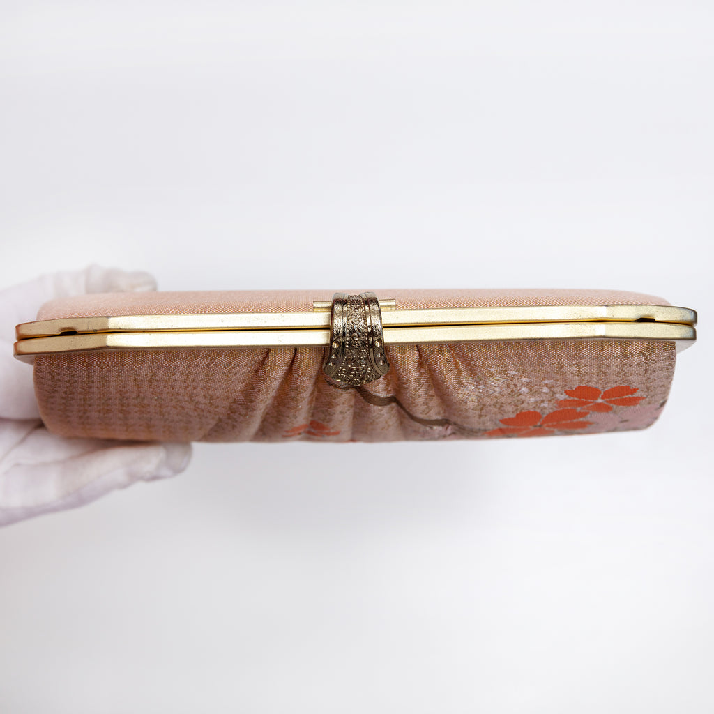 View of vintage Japanese 1970s gold clutch closed with the chain strap tucked inside.
