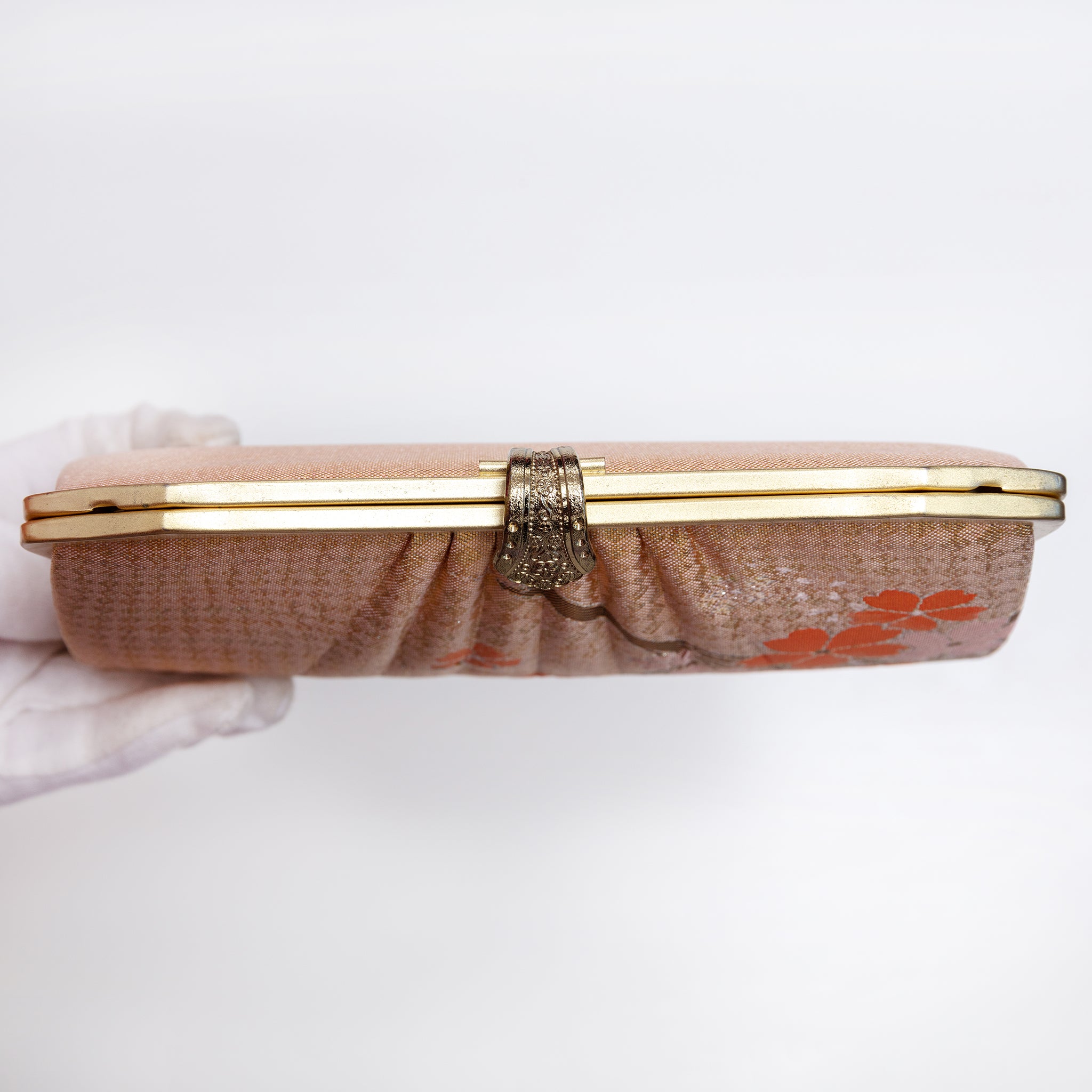 View of vintage Japanese 1970s gold clutch closed with the chain strap tucked inside.