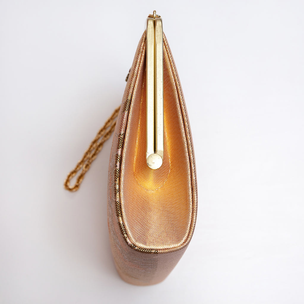 Side view of vintage Japanese clutch bag showing metallic woven gold silk panel