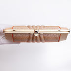 View of top of vintage clutch bag gold frame with the strap hinges and chain strap tucked inside the bag.