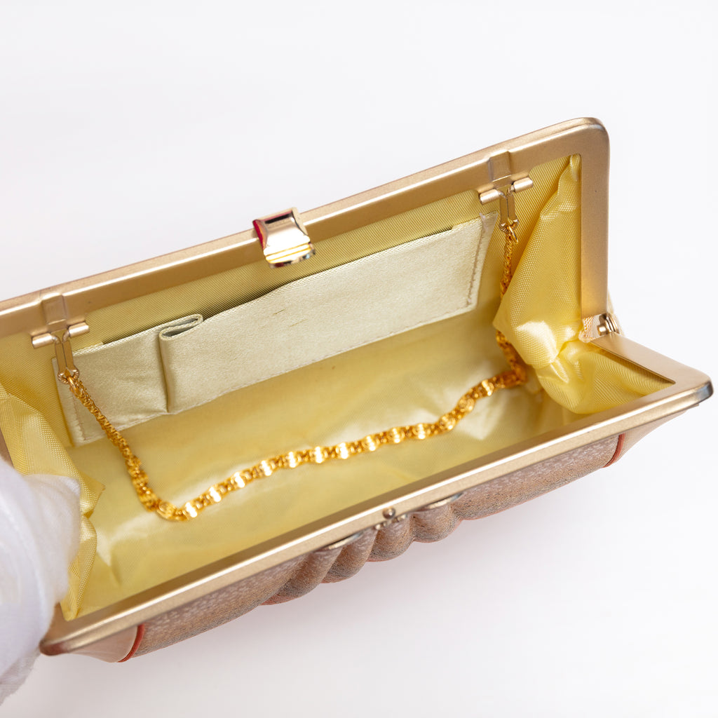 Open vintage Japanese silk clutch bag with gold-tone chain tucked inside
