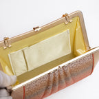 Open vintage Japanese silk clutch bag with strap hinges extended so chain is out, cream silk lining, mark on pocket.