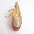 Side view showing the unusual projecting checkerboard-woven metallic gold silk panel and orange-gold piping, gold chain strap