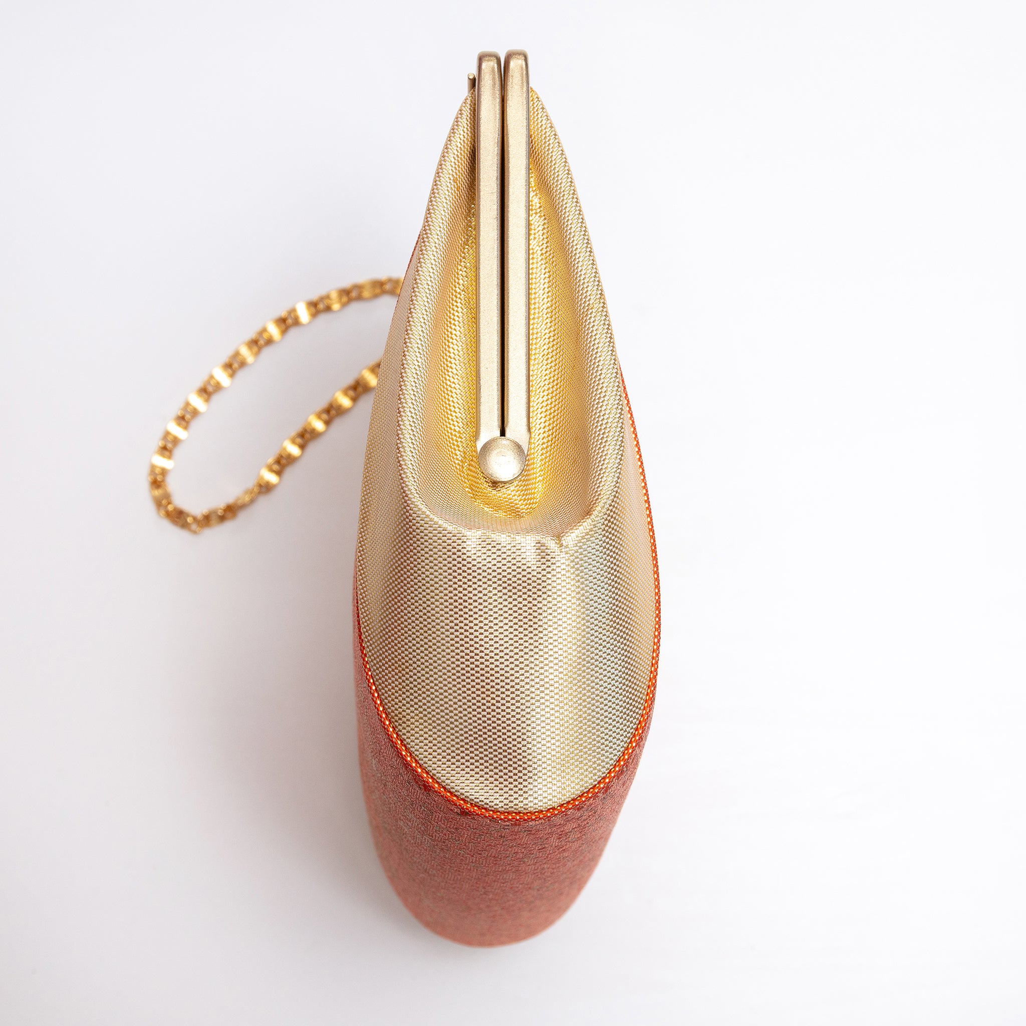 Side view showing the unusual projecting checkerboard-woven metallic gold silk panel and orange-gold piping, gold chain strap