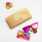 Vintage Japanese silk clutch bag with floral design on a white background with sunglasses and hairpin.