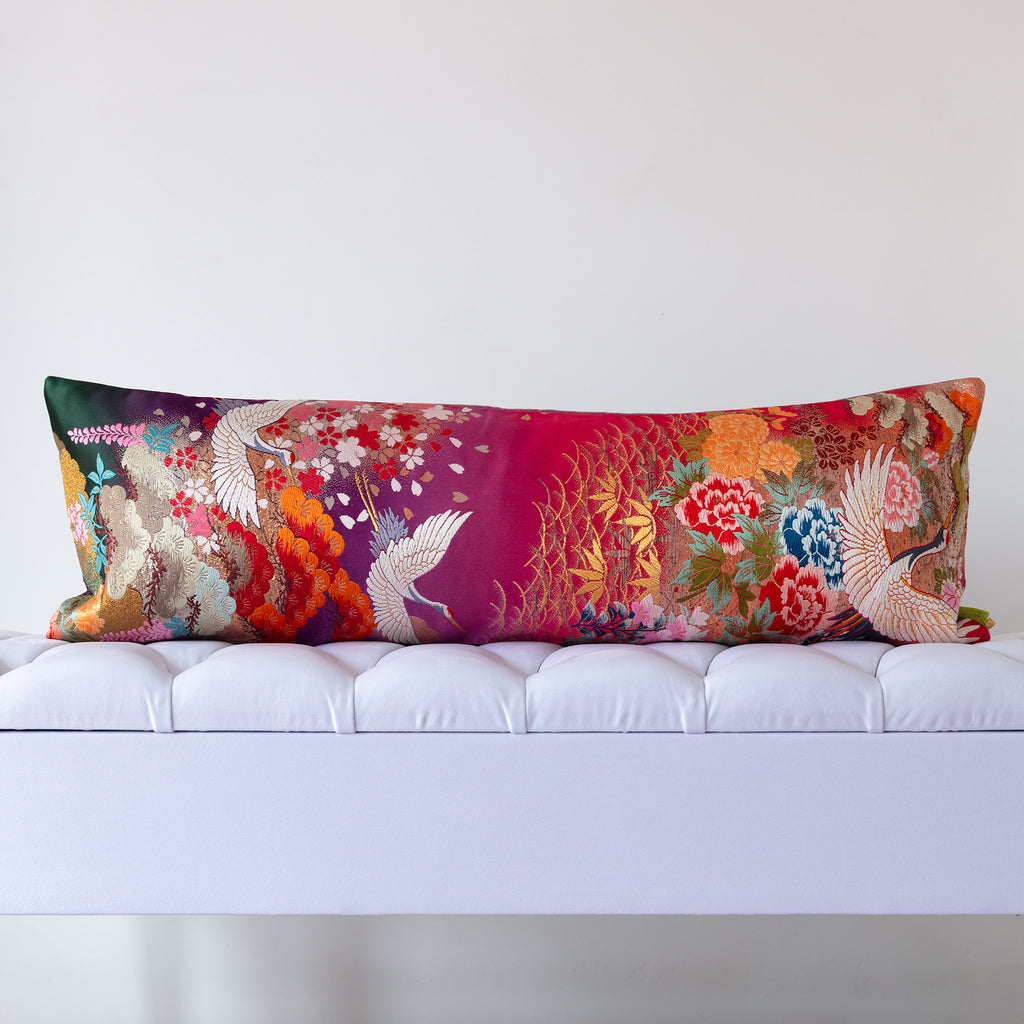 Purple and pink ombre silk kimono bolster cushion with white cranes and ornate florals, crafted from vintage Japanese silk