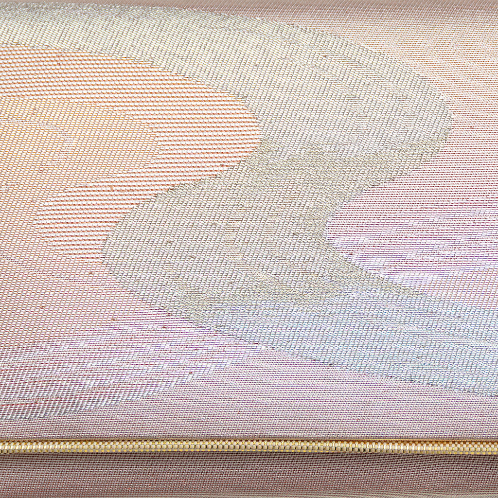 Close-up of iridescent rainbow river pattern on textured vintage Japanese kimono clutch fabric and detail of gold trim accent.