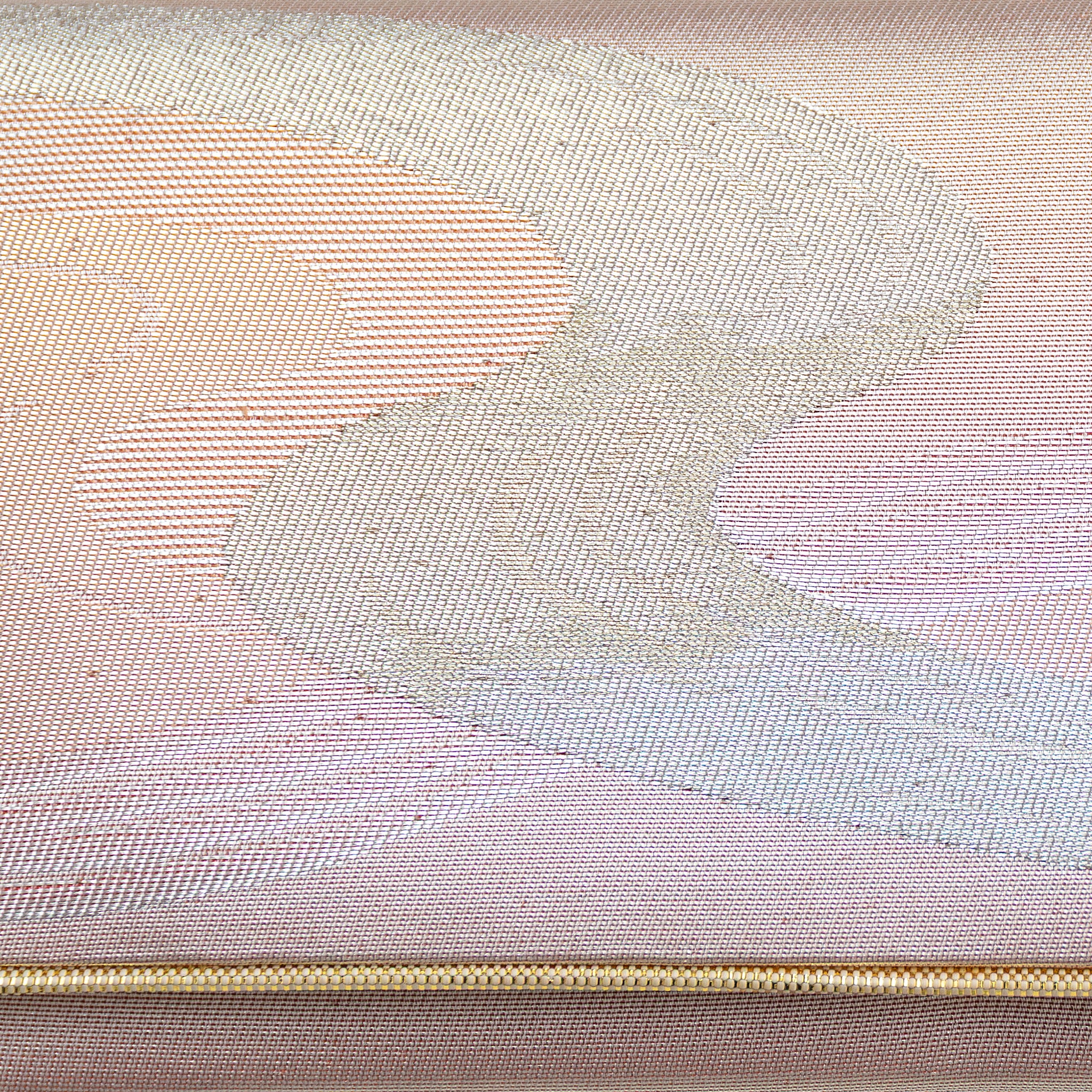 Close-up of iridescent rainbow river pattern on textured vintage Japanese kimono clutch fabric and detail of gold trim accent.