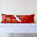 red vintage kimono silk bolster cushion with white cranes and gold fan motifs on neutral bench