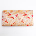 Back view of gold vintage Japanese silk clutch bag with small fan and flower pattern
