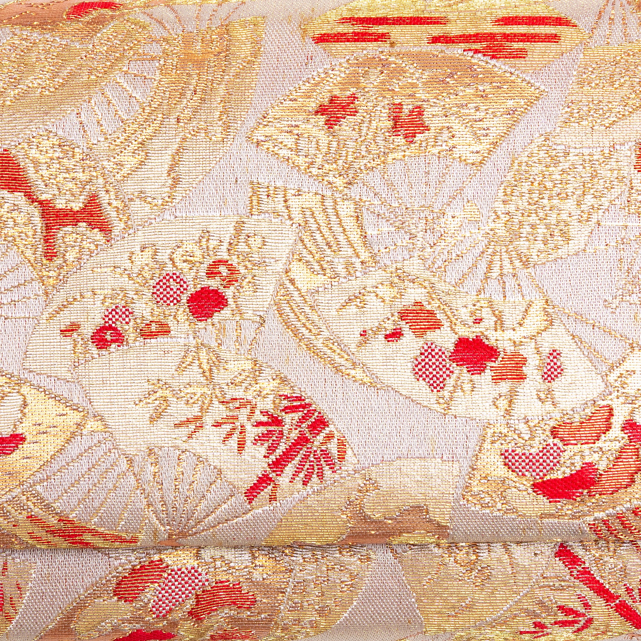 Close-up of tiny Ōgi fan, flower and bamboo design woven into gold kimono silk