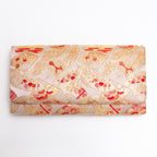 Front view of gold red kimono silk clutch bag with all-over fan pattern