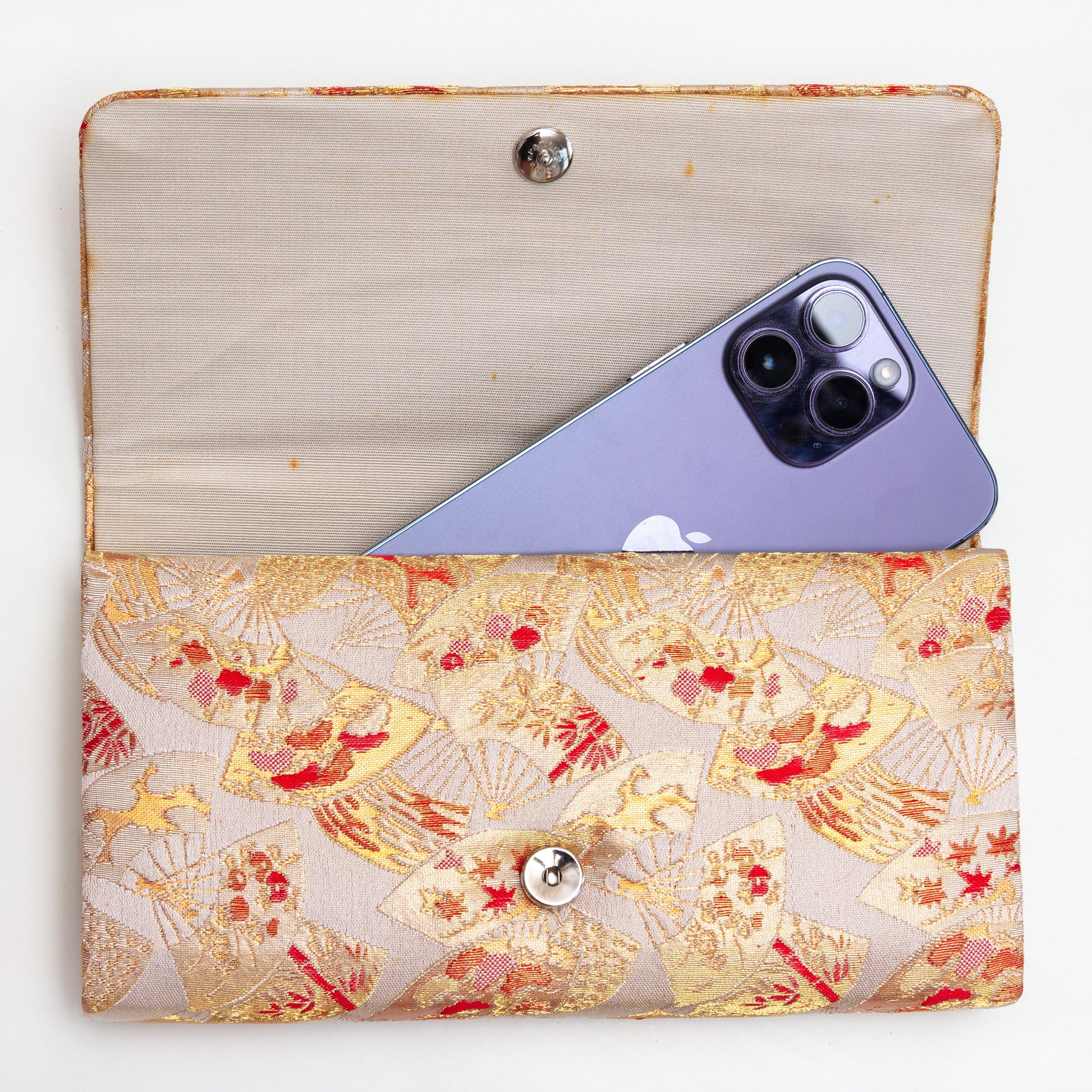 Gold red kimono silk clutch bag shown with iPhone 14 Pro Max for scale