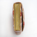 Side view of gold red envelope clutch showing folded concertina sides in bright gold.