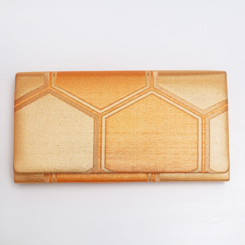 Front view of gold kimono silk envelope clutch with large Kikkō hexagon pattern