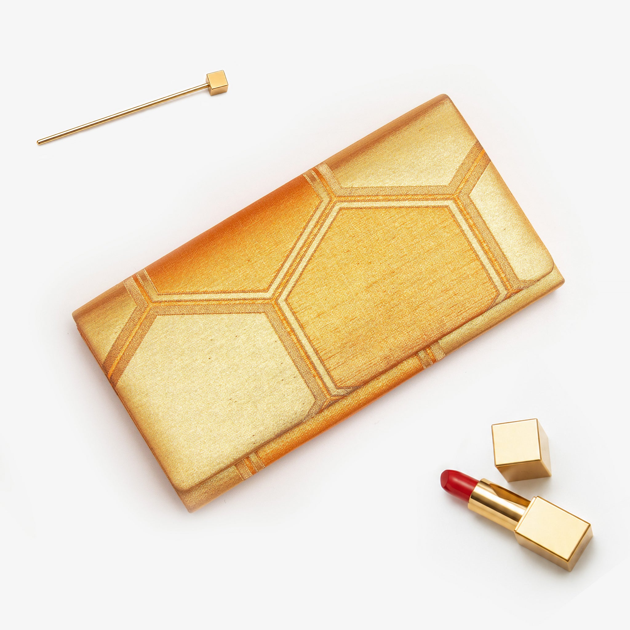 Gold vintage Japanese silk clutch bag with hexagon honeycomb pattern styled with lipstick and hairpin