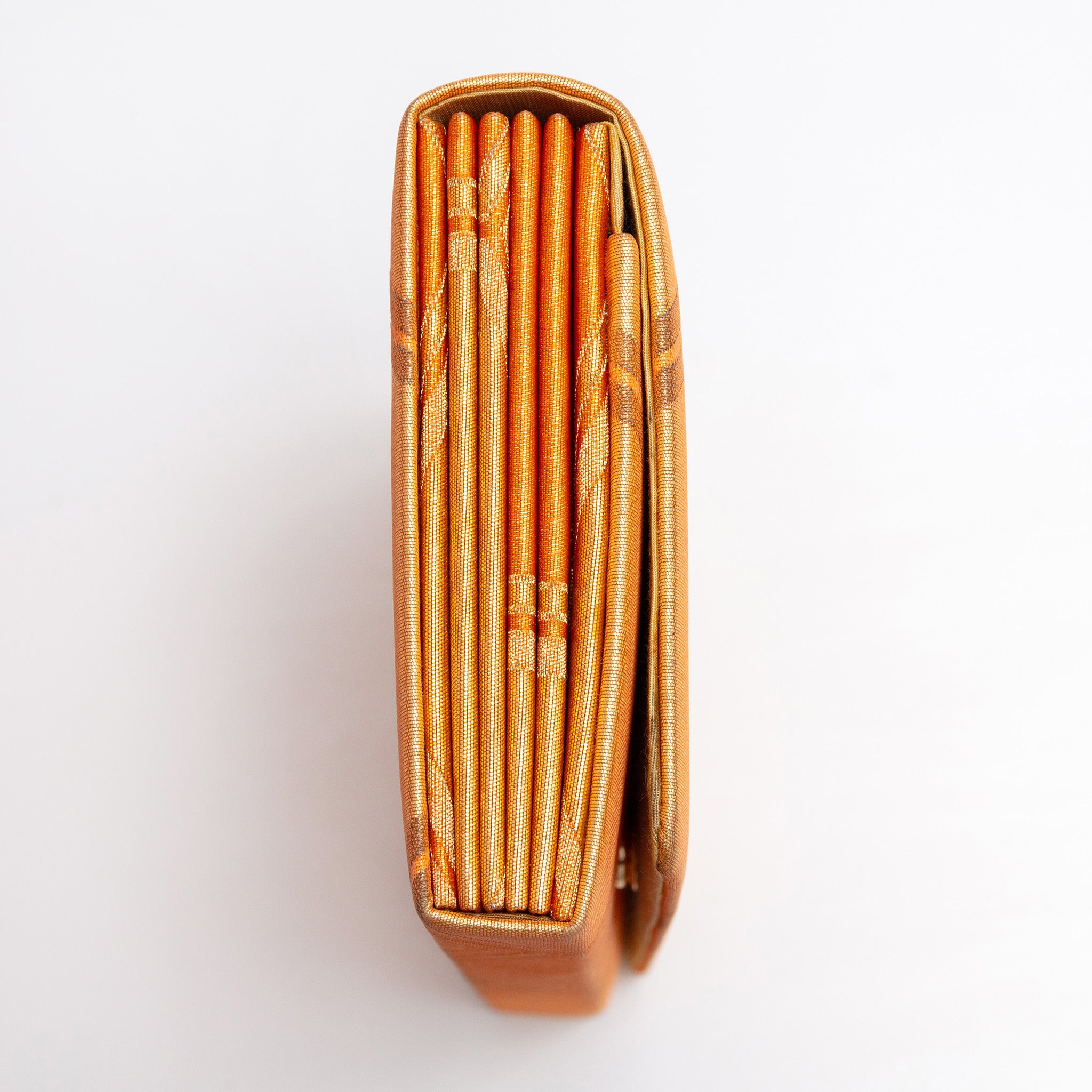 Side view of metallic orange and gold vintage Japanese envelope clutch showing folded construction