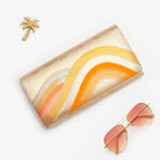 Gold orange vintage Japanese silk clutch bag styled with sunglasses and palm brooch
