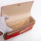 Open kimono silk clutch bag showing cream-gold lining, front section and 2 interior pockets.