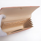 Open vintage Japanese clutch purse showing cream and gold silk interior with three pockets