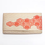Front view of vintage Japanese gold silk clutch bag with red Kikkō hexagons