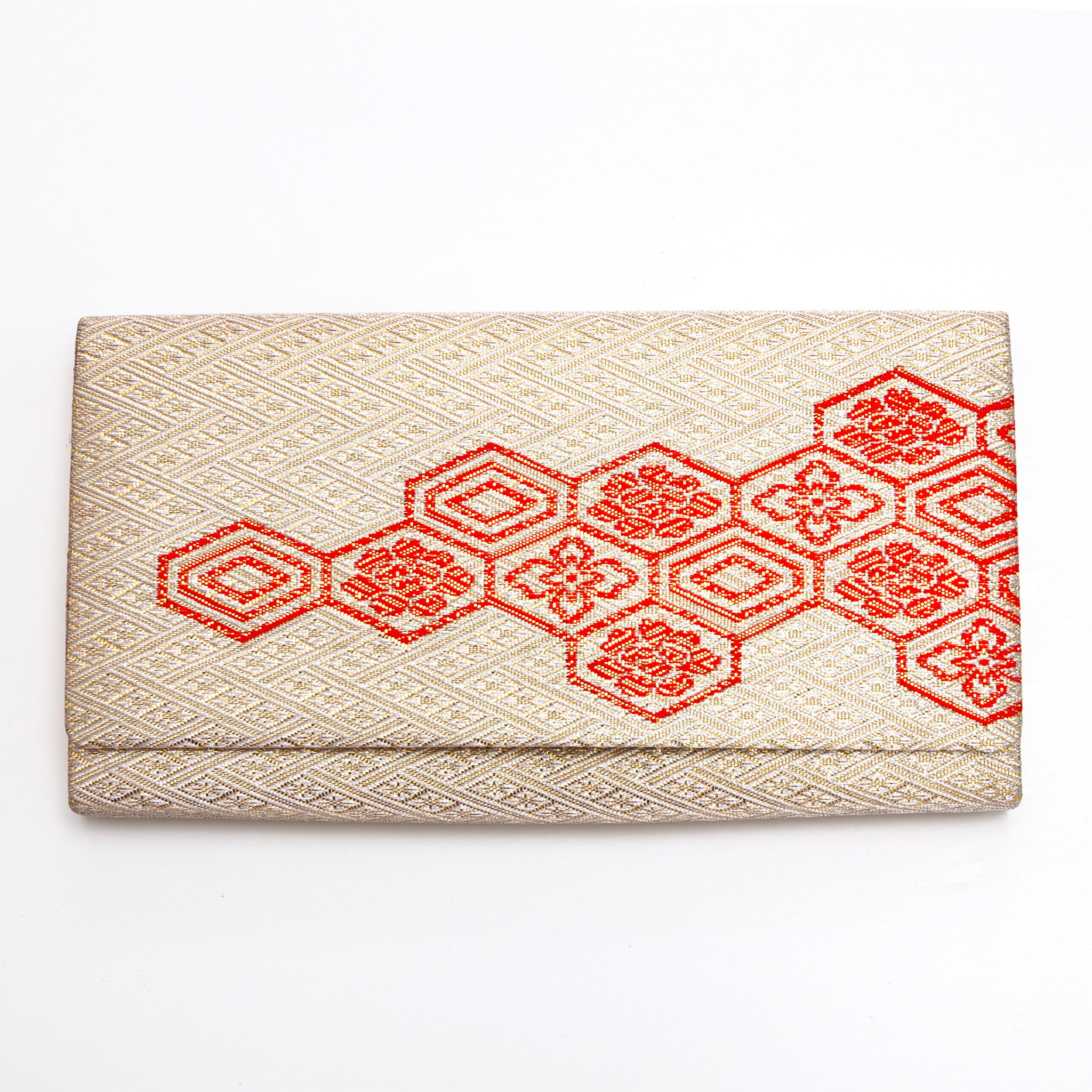 Front view of vintage Japanese gold silk clutch bag with red Kikkō hexagons
