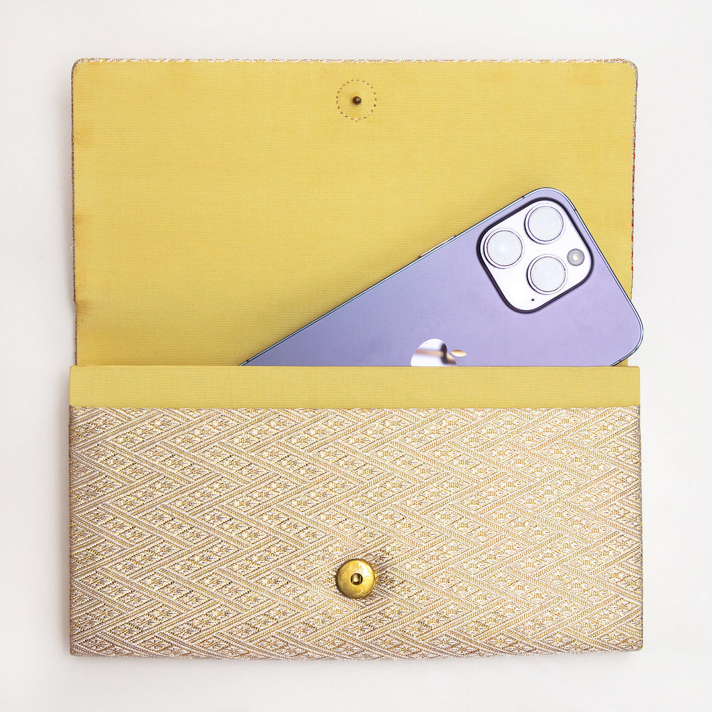 Vintage Japanese clutch bag shown with iPhone for scale inside the silk interior