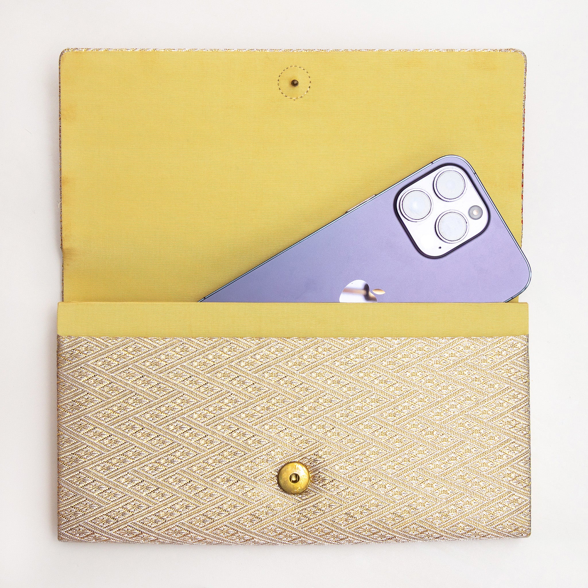 Vintage Japanese clutch bag shown with iPhone for scale inside the silk interior