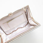 Interior view of vintage Japanese silk clutch bag showing white silk lining, internal pocket and silver chain strap tucked inside.