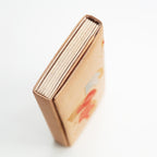 Side view of a vintage Japanese silk clutch bag showing gold folded side panel.