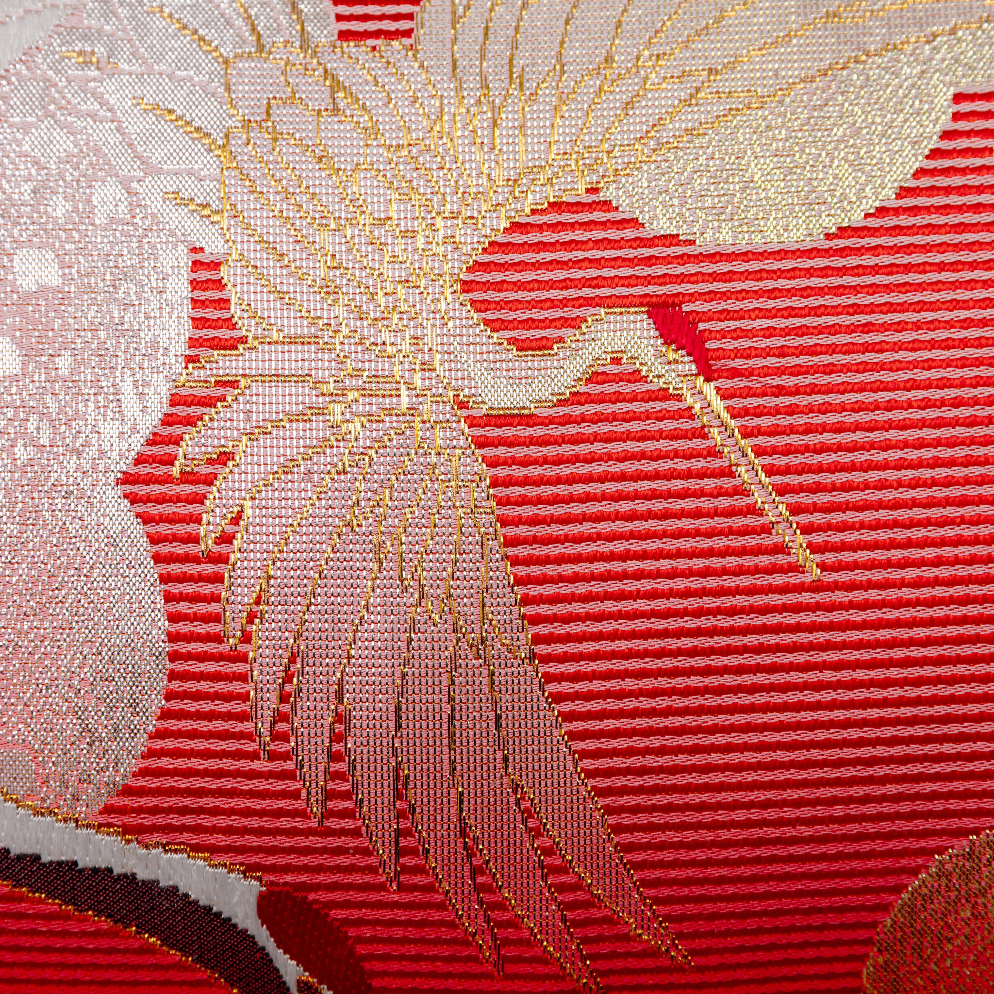 Close-up of the richly textured purple velvet backing and intricate silk crane embroidery on the pillow's edge detail.