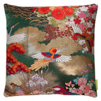 Close-up of green silk fabric with intricate gold velvet embroidery on the cushion's corner, highlighting detailed