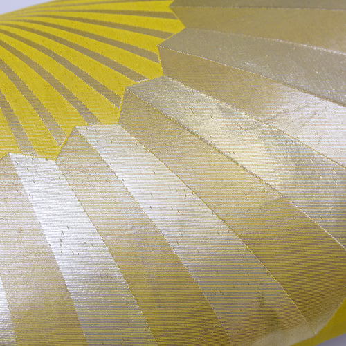 Close-up of the pillow's golden fan pattern over chartreuse silk, detail of a long silk bolster cushion made from vintage maru obi from Japan.