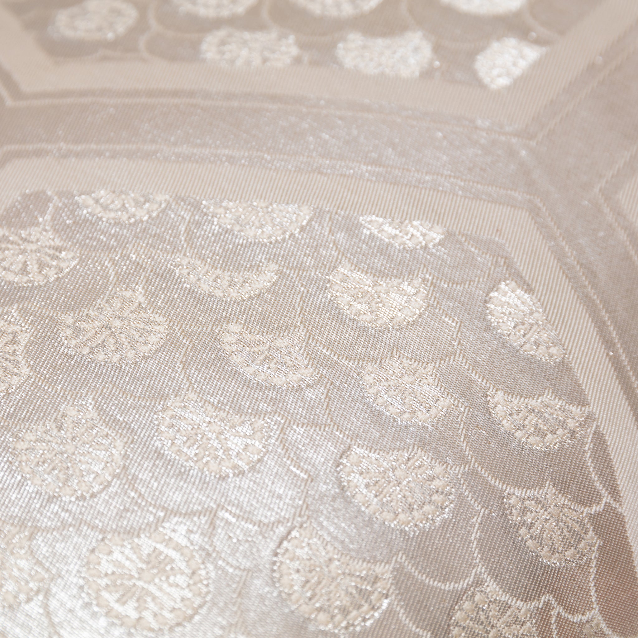 Close-up of textured oyster velvet back and subtle stitching details on the metallic silver long bolster cushion.
