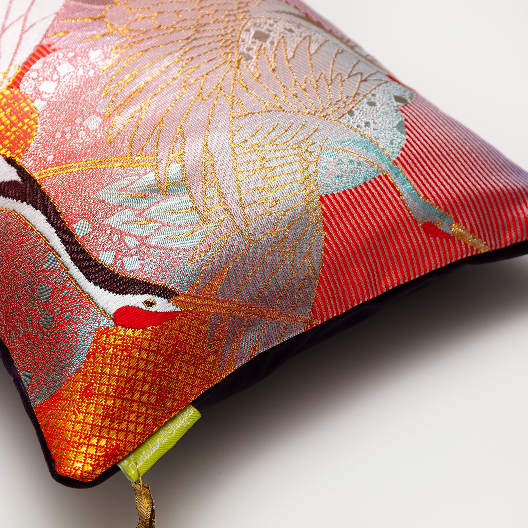 Close-up of the pillow's vibrant red silk fabric highlighting intricate Cranes vintage kimono silk pattern and luxurious