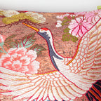 Close-up of purple velvet trim and subtle embroidered cherry blossom details along the pink ombre fabric edge of the bolster