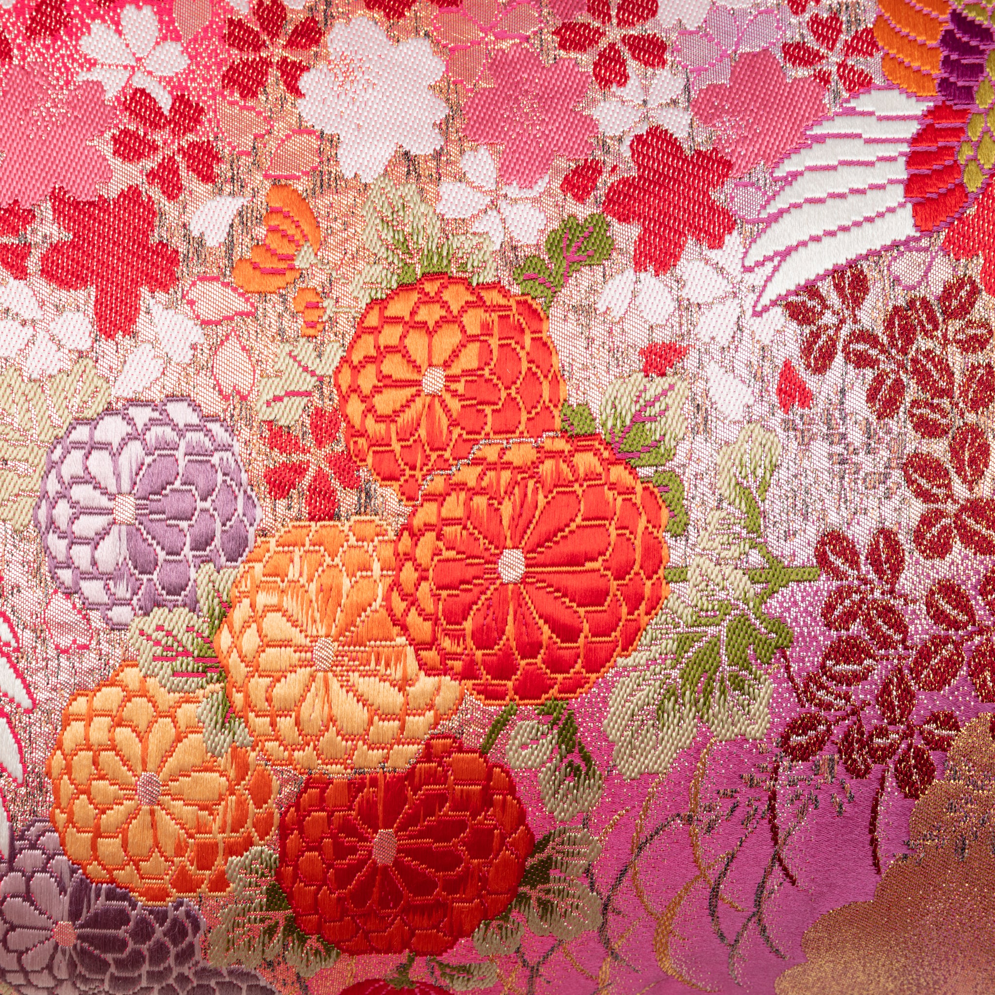 Close-up of the embroidered flying cranes and deep purple velvet fabric highlighting intricate stitching details on the Red