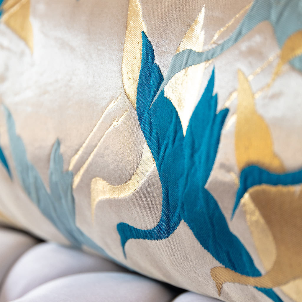 Close-up of teal crane wings in flight woven on shimmering pale gold Japanese obi silk
