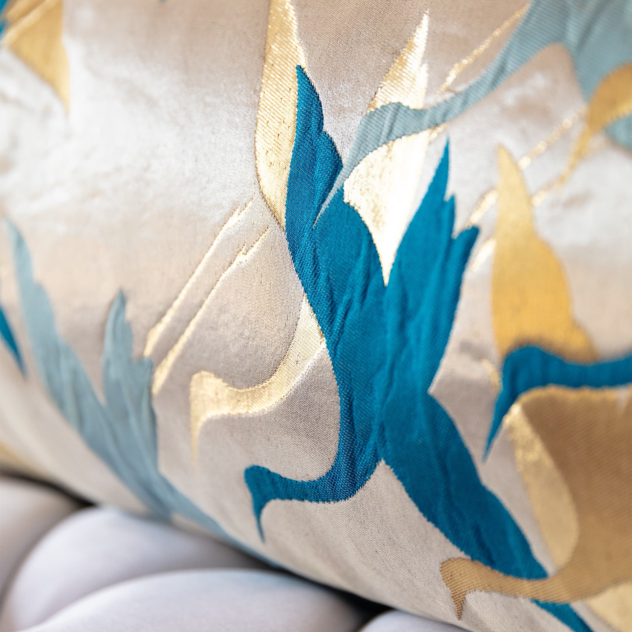 Close-up of teal crane wings in flight woven on shimmering pale gold Japanese obi silk
