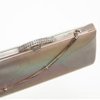 Vintage Japanese silk clutch bag showing silver frame with filigree detail and decorative silver chain strap. Iridescent silver silk front panel.