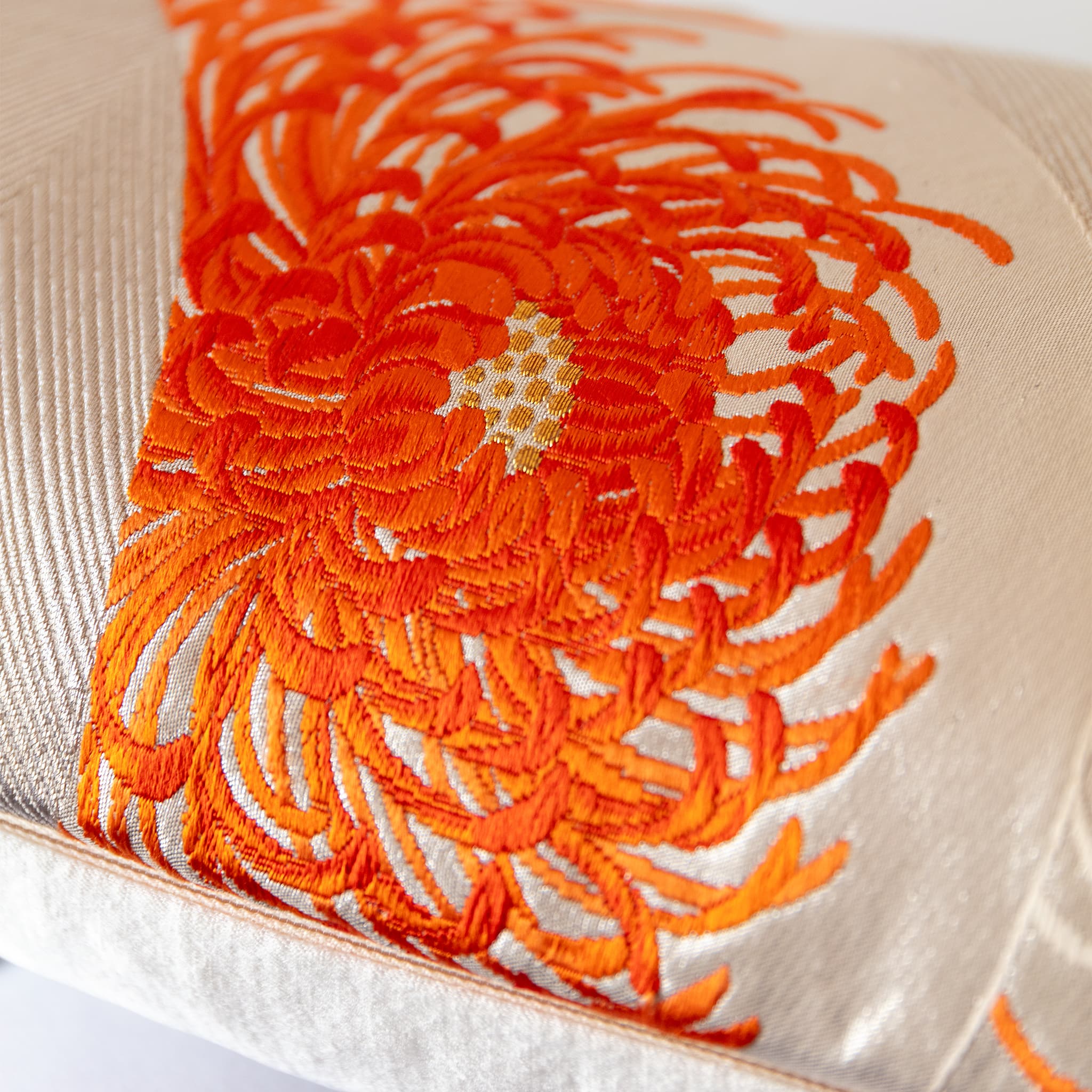 Spider chrysanthemum bloom in flame orange with gilt woven centre, close-up detail of vintage Japanese Fukuro Obi silk