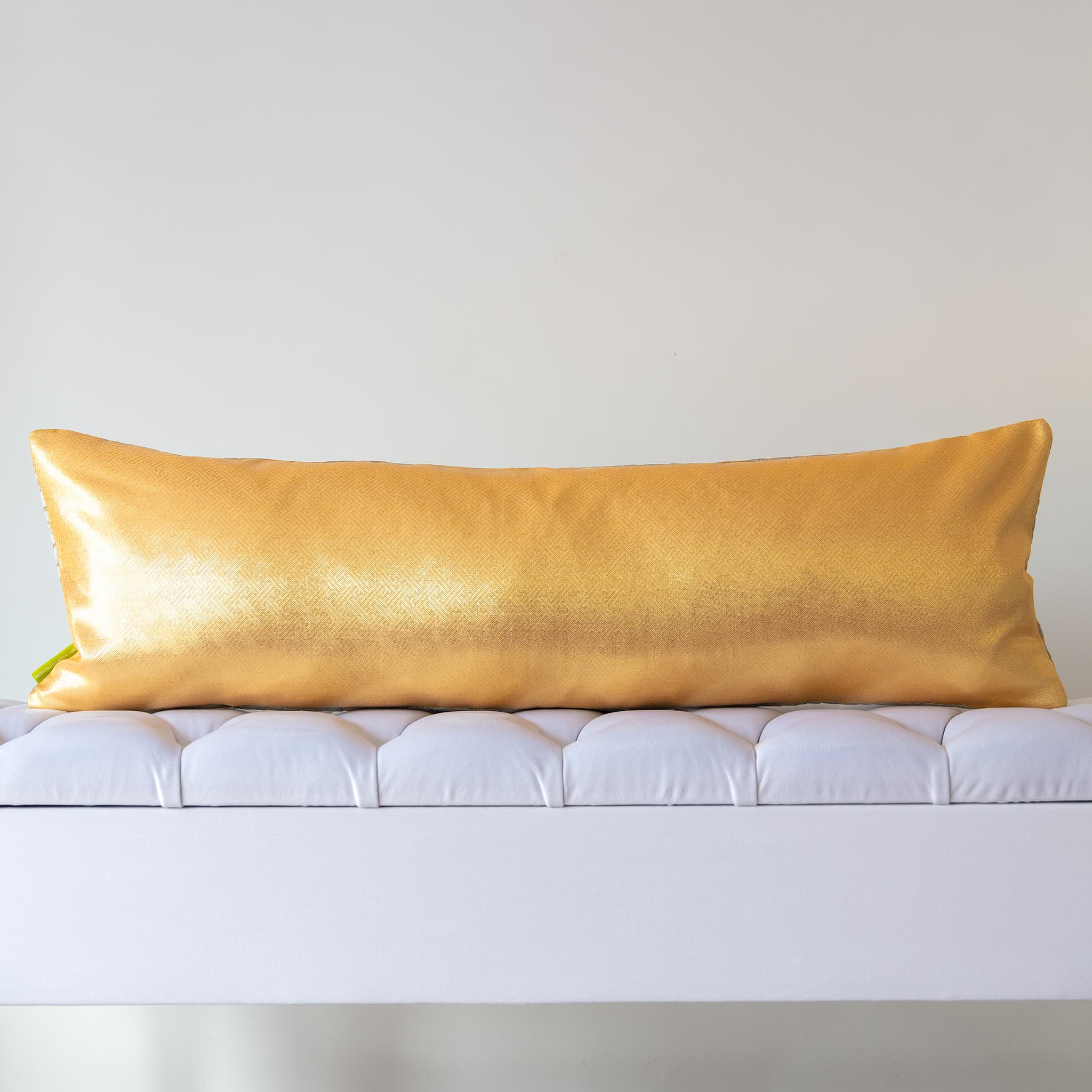 Plain gold silk reverse of long kimono bolster cushion on white bench