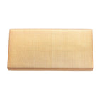 Reverse view of a vintage gold silk Japanese clutch bag on a white background.