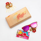 Metallic gold vintage silk clutch bag from Japan with red fans design, surrounded by accessories on a white background.