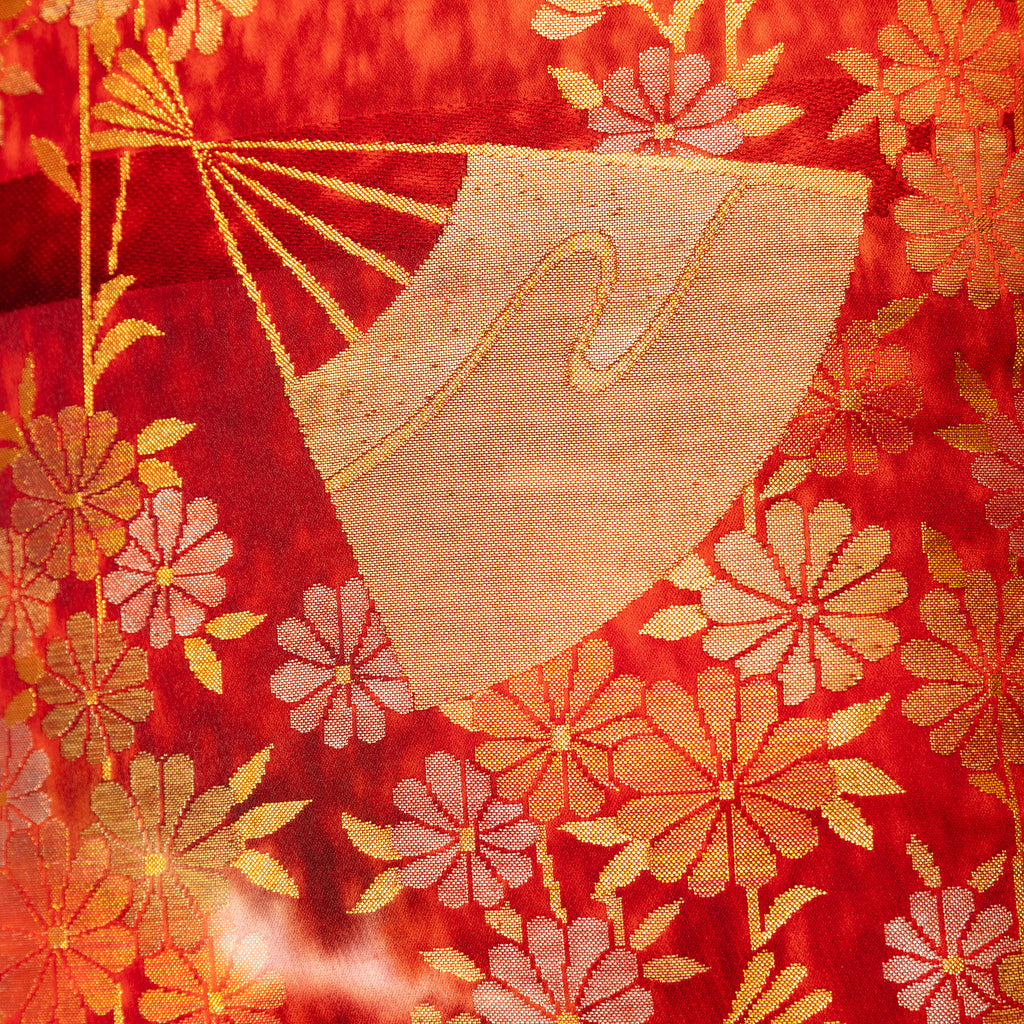 close up of vintage kimono silk uchikake with gold fans and flowers over red