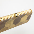 Gold vintage Japanese silk clutch with geometric pattern on a white background