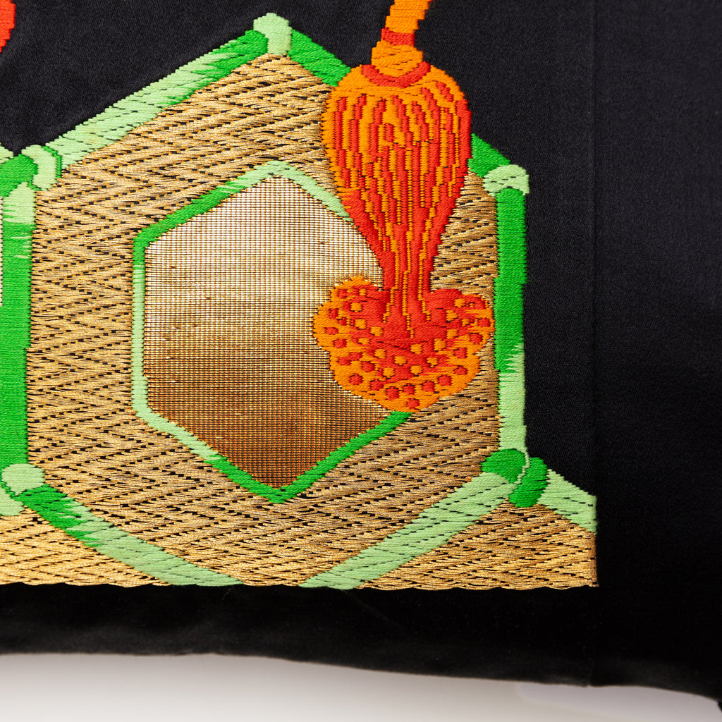 Close-up of gold and black geometric pattern on vintage Obi silk pillow fabric, highlighting intricate texture and fine